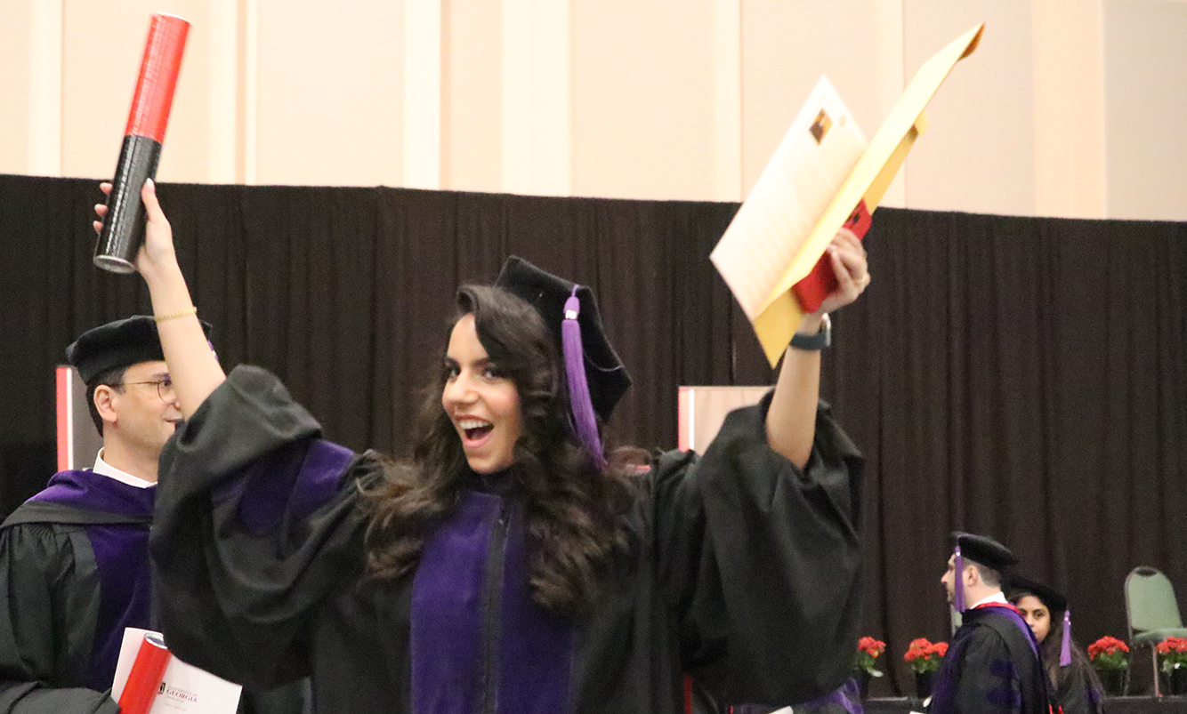 Mona Abboud celebrates with her new diploma.