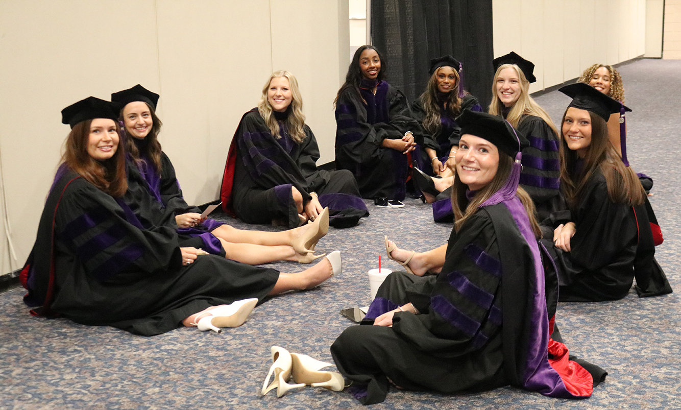 Students sit together and rest before the main event. They are (clockwise from left): Anna Mobley-Hipps, Casey Wofford, Hannah Ryninger, Cori Robinson, Jordan Jackson, Alexa Hernandez, Celina Cotton, Davis Bryson and Julia Krzeminski.