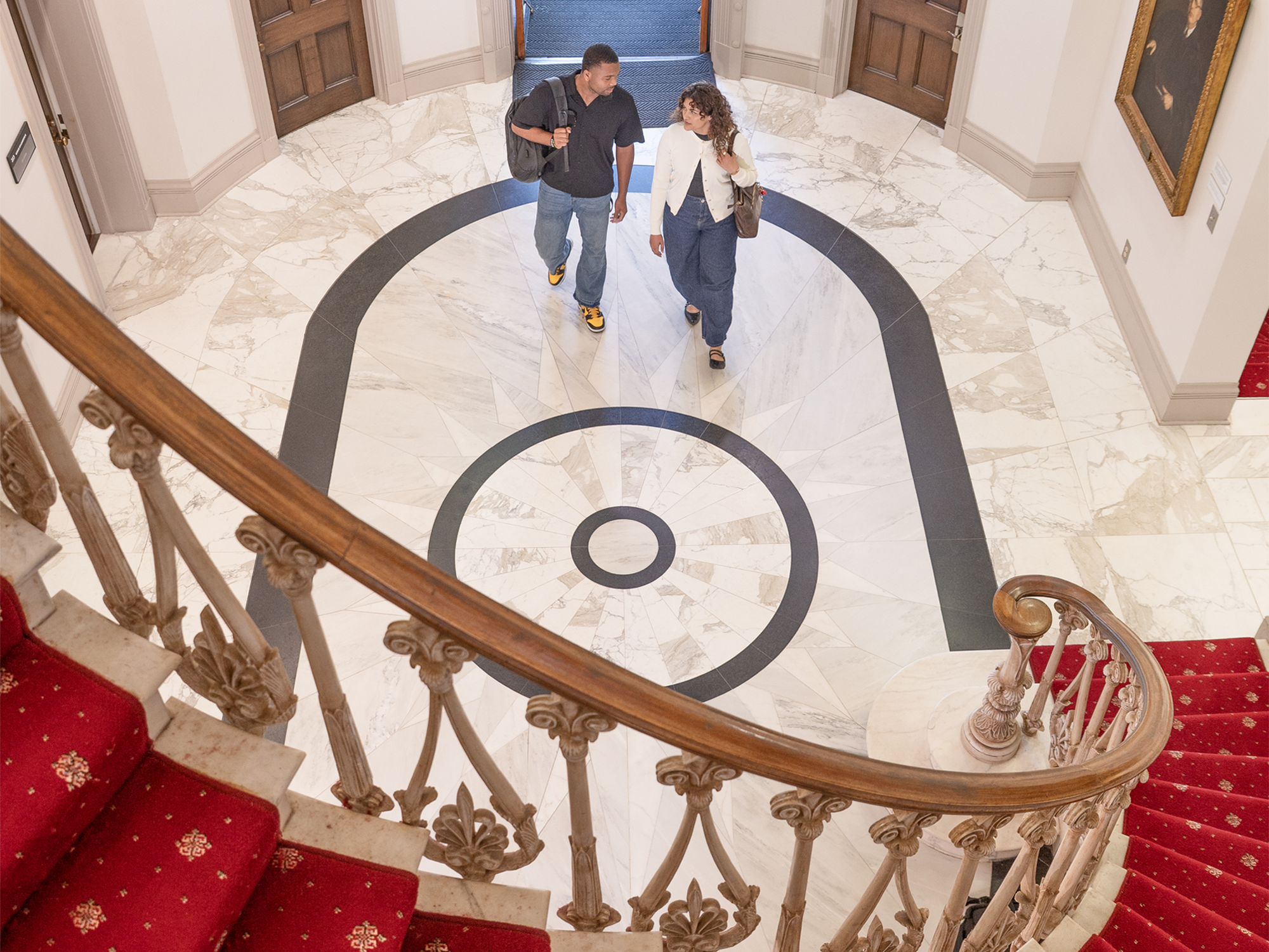 Two students walking in the School of Law rotunda